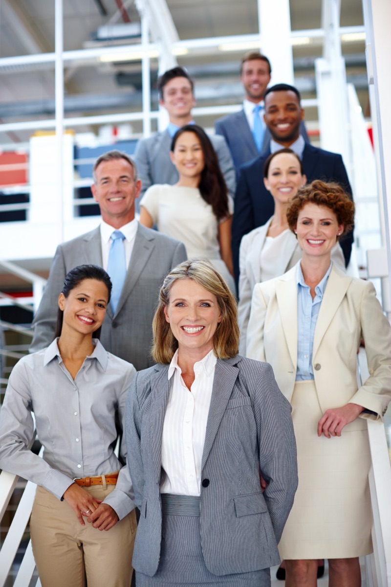 A diverse group of business leaders standing together in an office